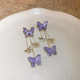 détails des Boucles d'oreilles papillons mauve et or