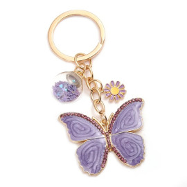 détails Porte-clés papillon violet avec perles de verre étoilées et fleurs